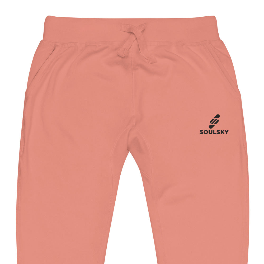 Half pic of pink unisex joggers with black embroidered logo on left thigh that says "SOULSKY".