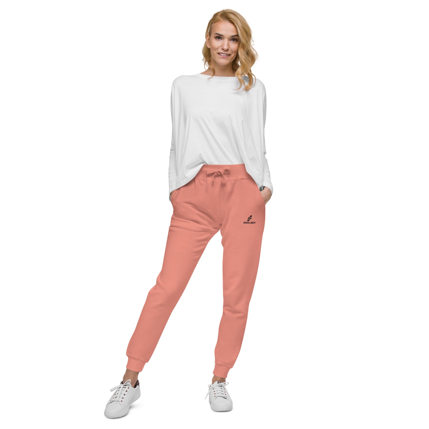 Female model wearing pink unisex joggers with black embroidered logo on left thigh that says "SOULSKY".