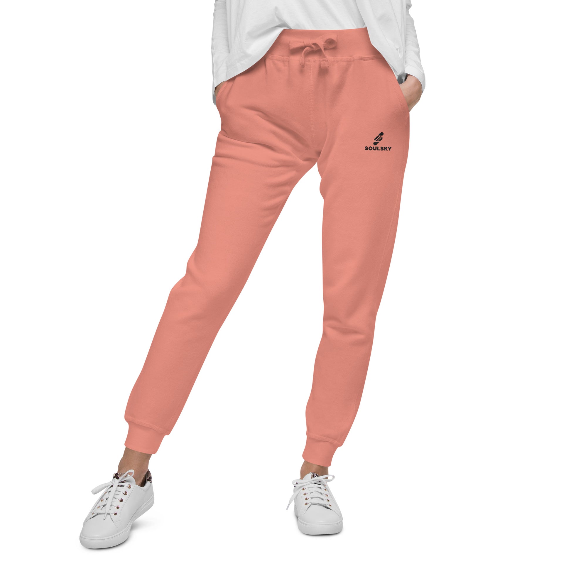 Bottom half pic of a female model wearing pink unisex joggers with black embroidered logo on left thigh that says "SOULSKY".
