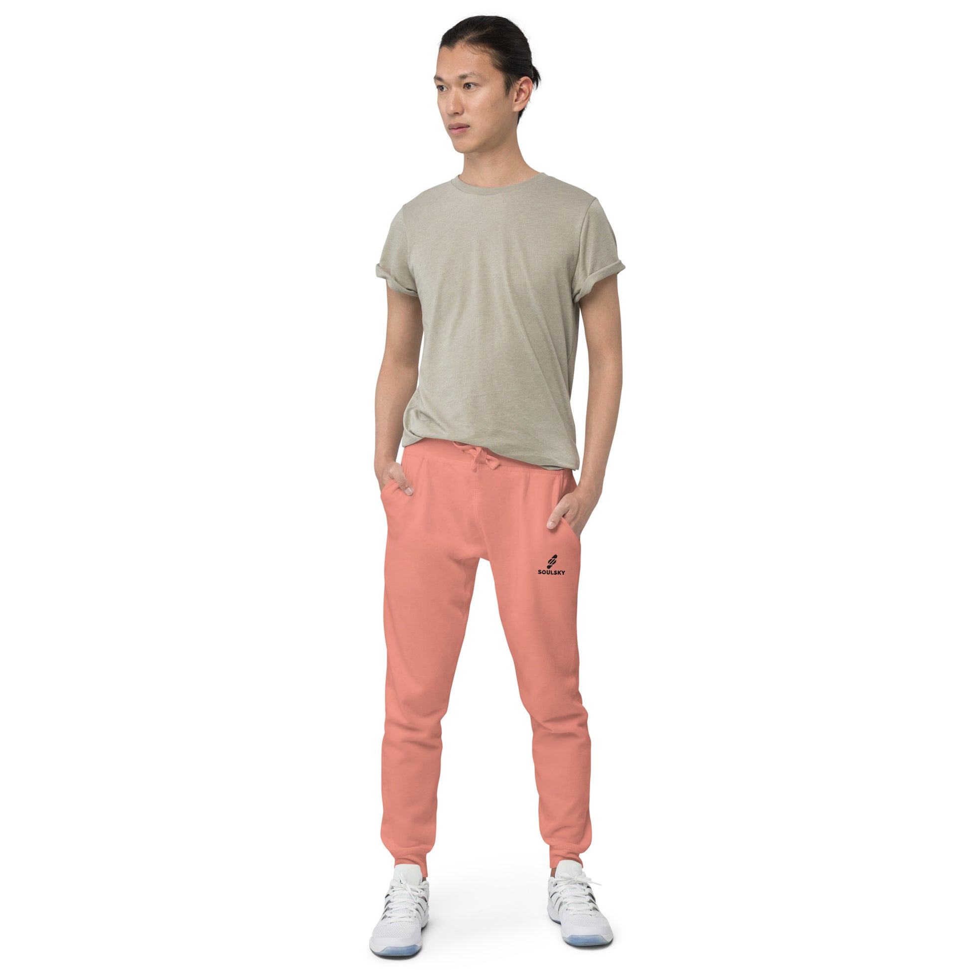 Male model wearing pink unisex joggers with black embroidered logo on left thigh that says "SOULSKY".