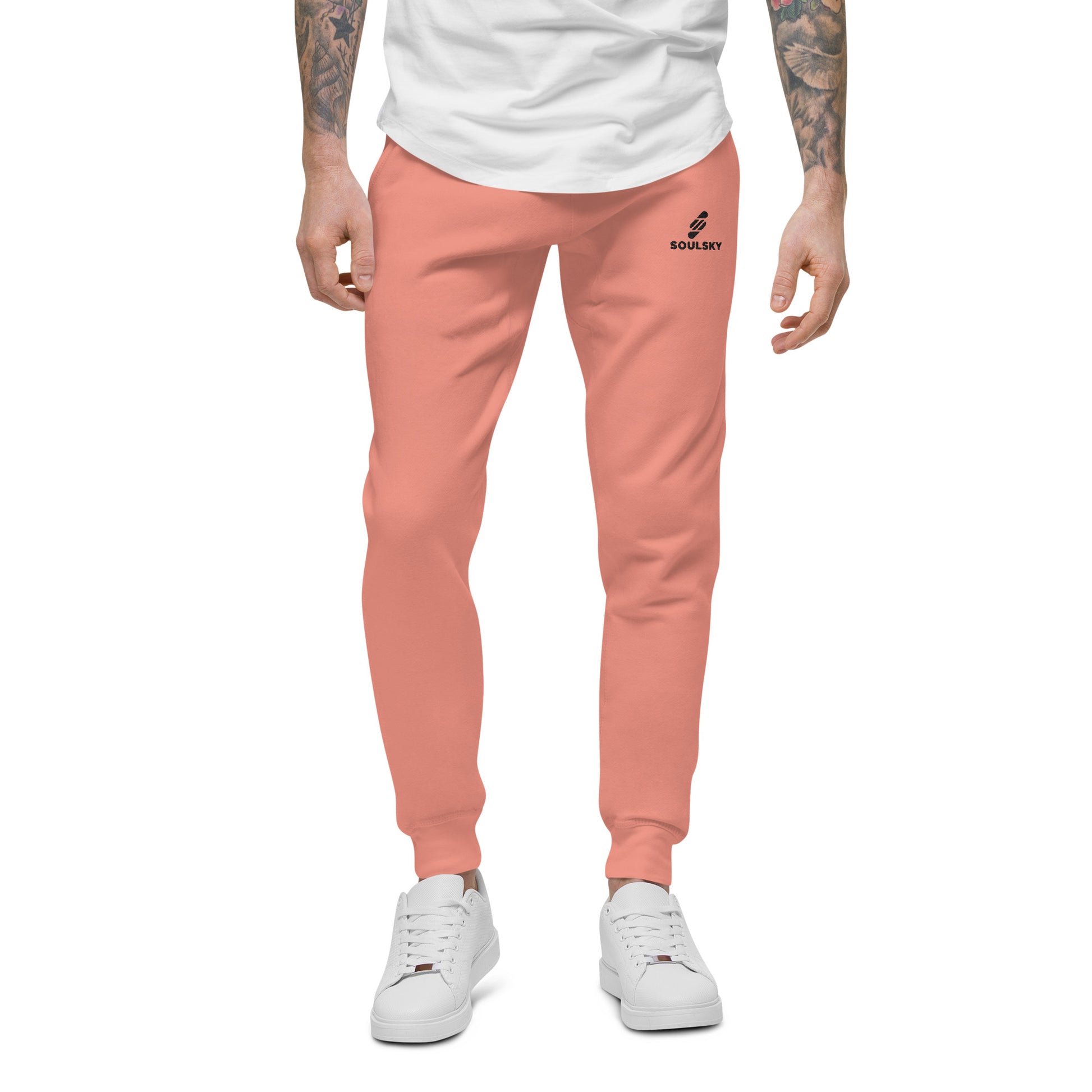 Male model wearing pink unisex joggers with black embroidered logo on left thigh that says "SOULSKY".
