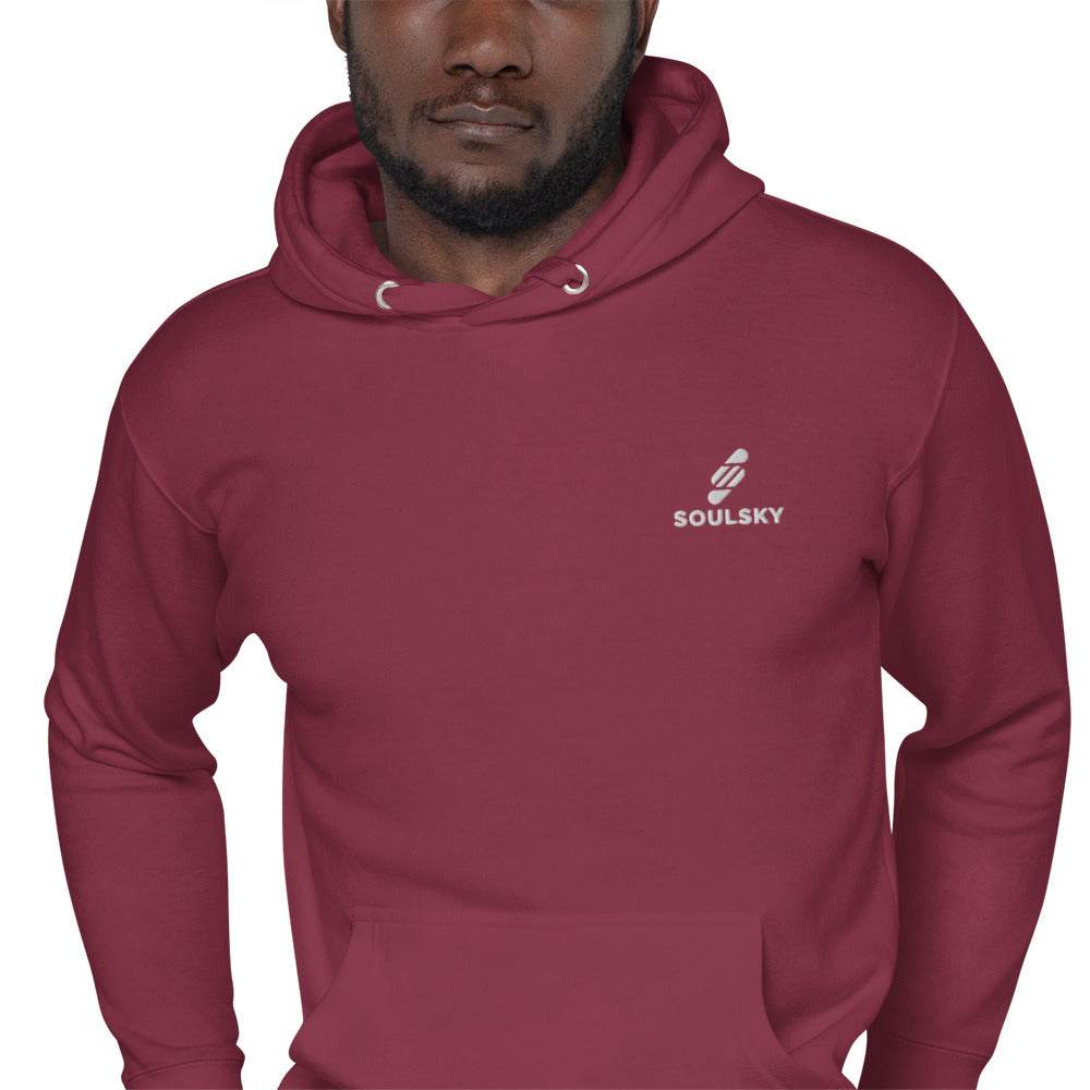 Black male model wearing a unisex premium maroon hoodie with a white embroidered SOULSKY logo on the left chest side.