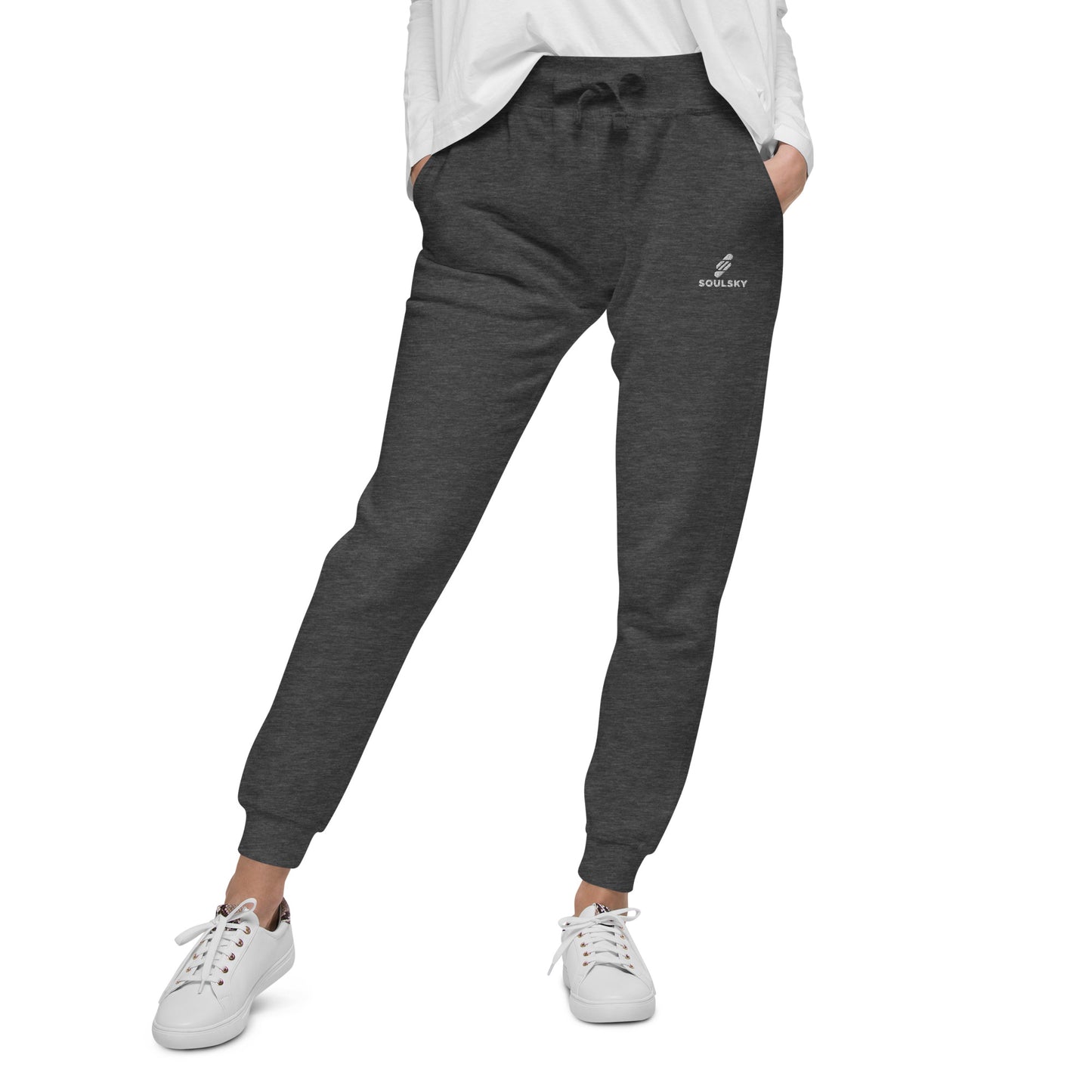 Female model wearing charcoal gray heather unisex joggers with white embroidered logo on left thigh that says "SOULSKY".