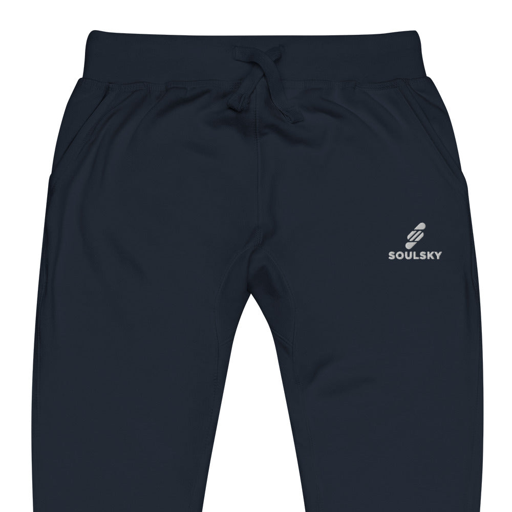 Close up of navy blue unisex joggers with white embroidered logo on left thigh that says "SOULSKY".