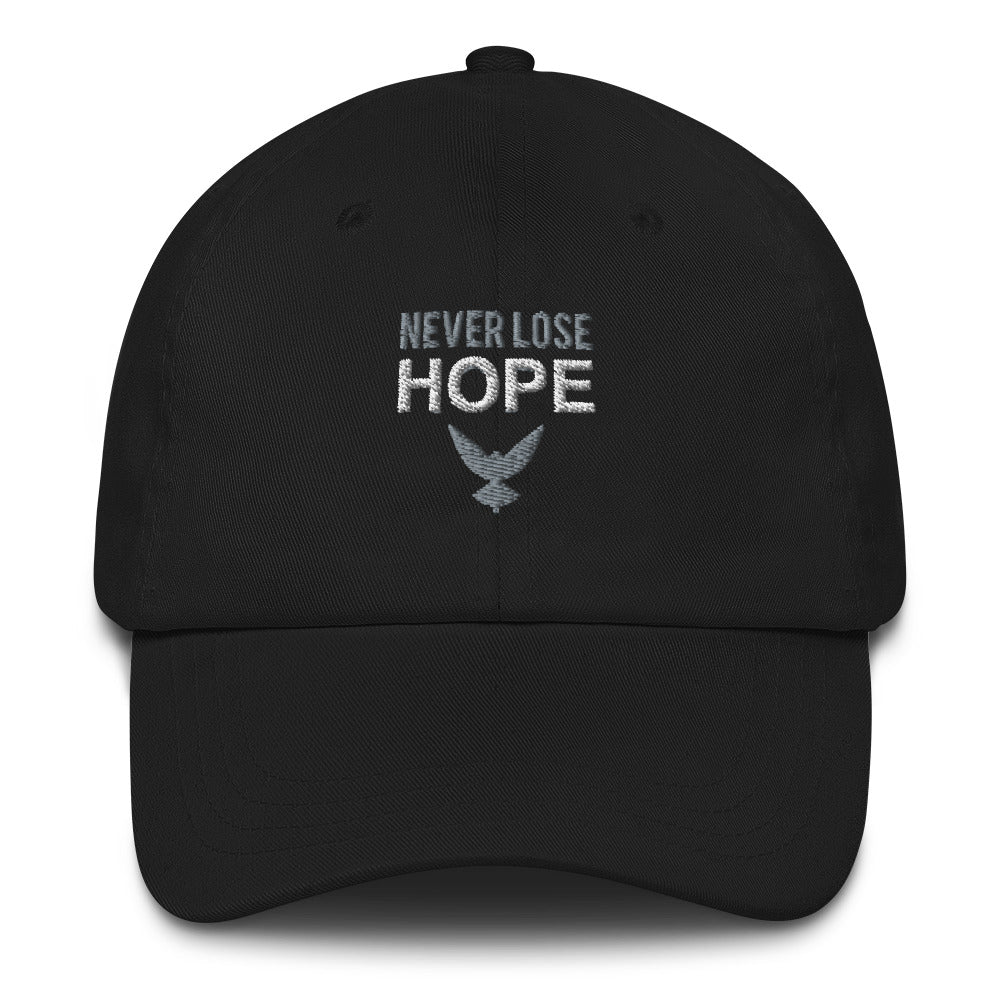 Black dad hat that has embroidered gray and white text that says "NEVER LOSE HOPE" with a gray eagle underneath. Close up pic.