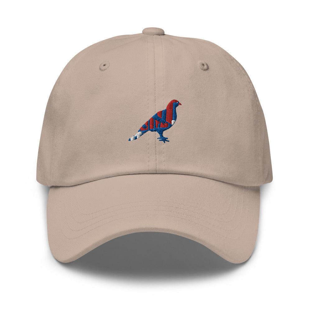 Beige dad hat with an embroidered blue, red, and white pigeon.