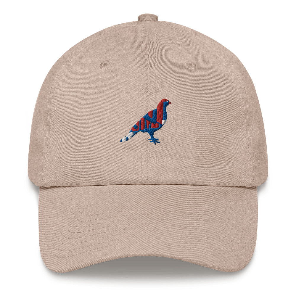 Beige dad hat with an embroidered blue, red, and white pigeon. Pic 2.