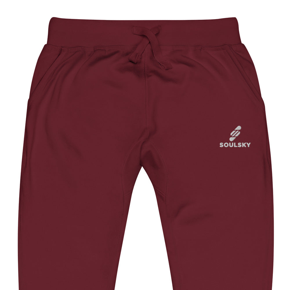 Half pic of maroon unisex joggers with white embroidered logo on left thigh that says "SOULSKY".
