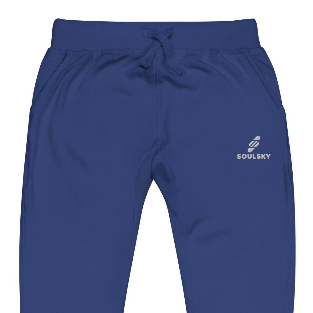 Half pic of royal blue unisex joggers with white embroidered logo on left thigh that says "SOULSKY".
