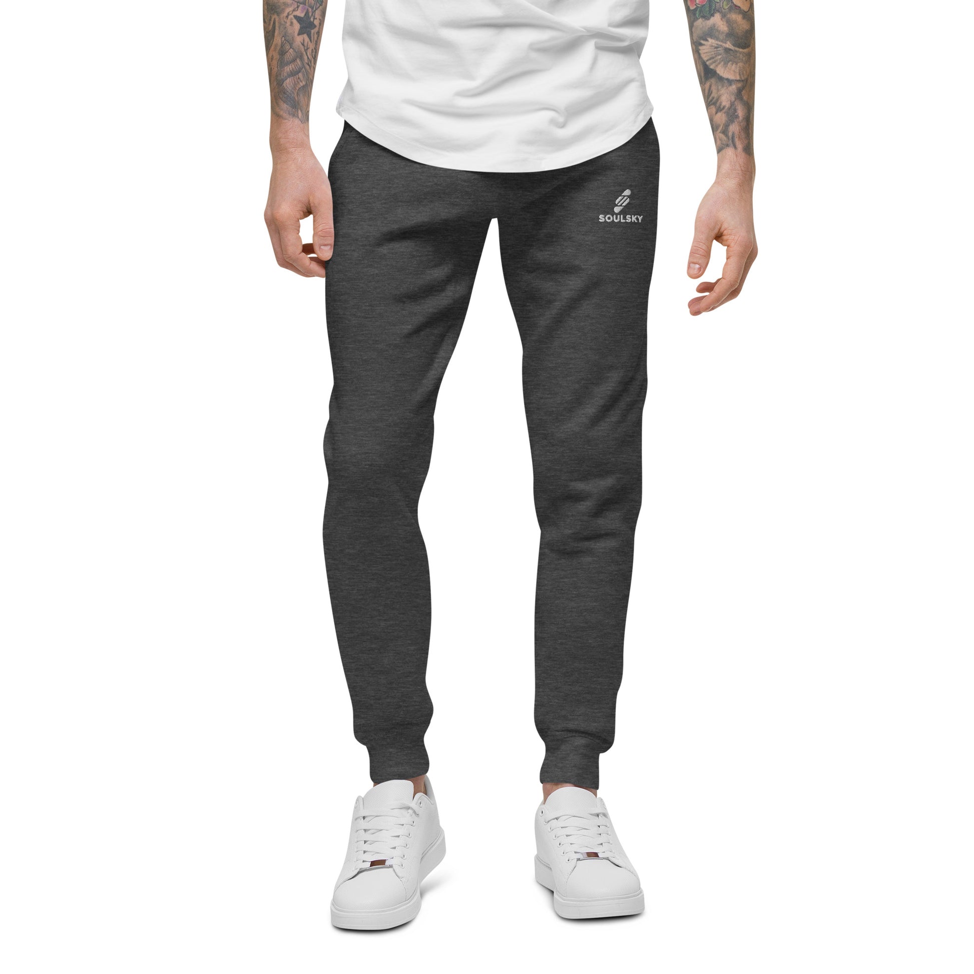 Male model wearing charcoal gray heather unisex joggers with white embroidered logo on left thigh that says "SOULSKY".