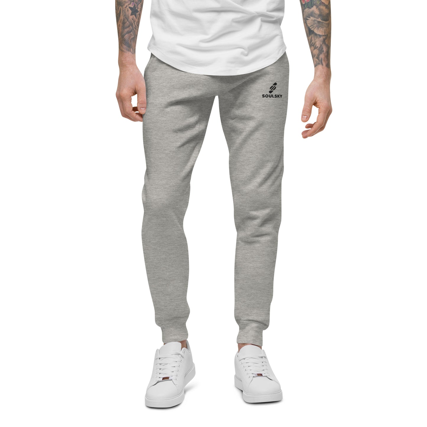 Male model wearing light gray unisex joggers with black embroidered logo on left thigh that says "SOULSKY".