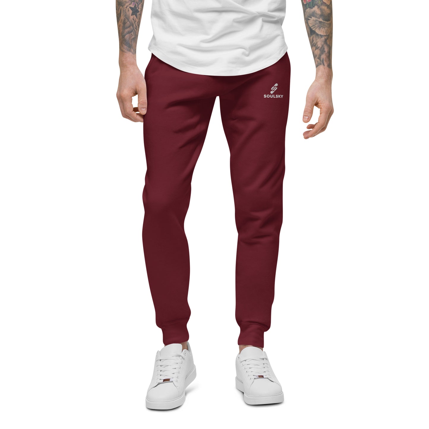 Male model wearing maroon unisex joggers with white embroidered logo on left thigh that says "SOULSKY".