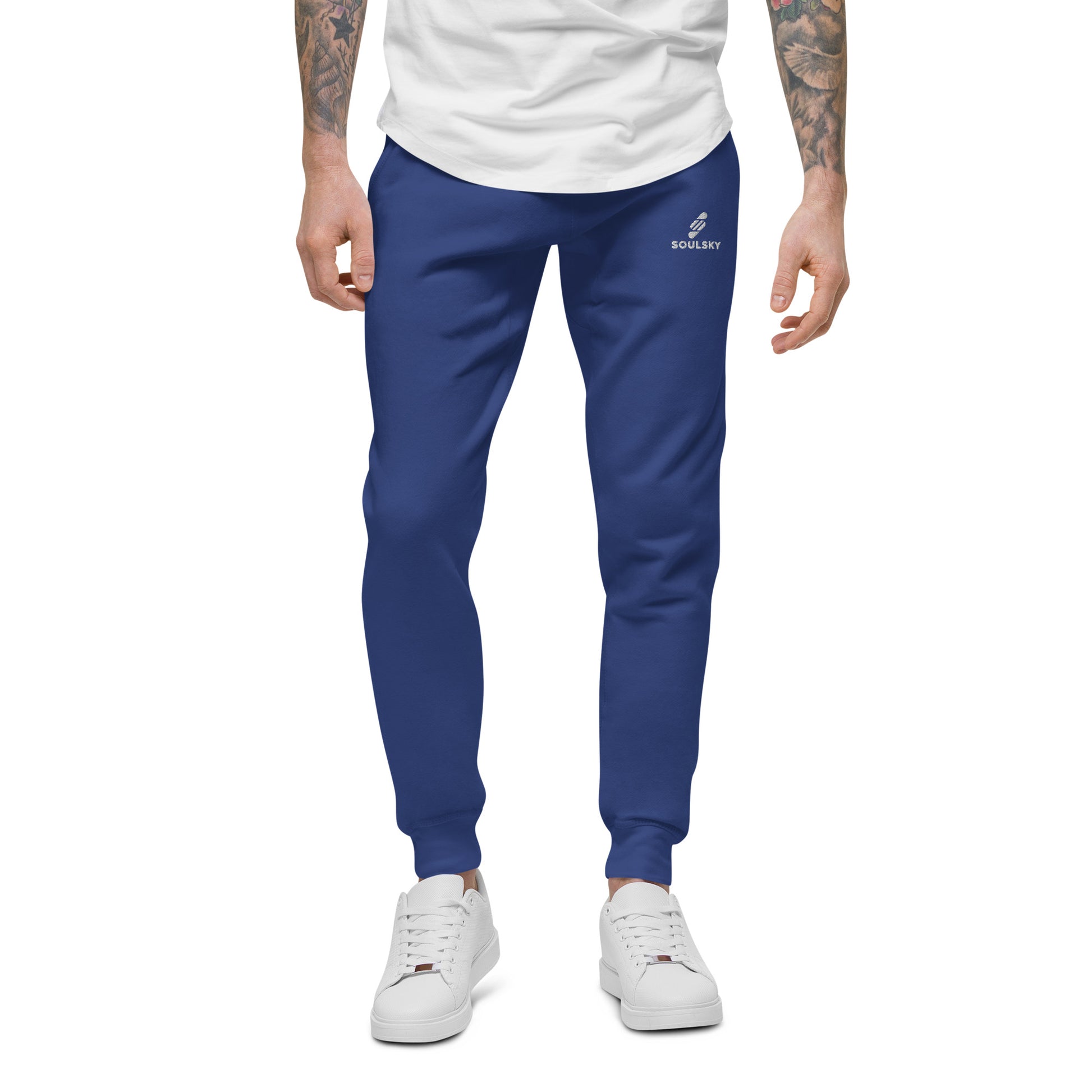 Male model wearing royal blue unisex joggers with white embroidered logo on left thigh that says "SOULSKY".
