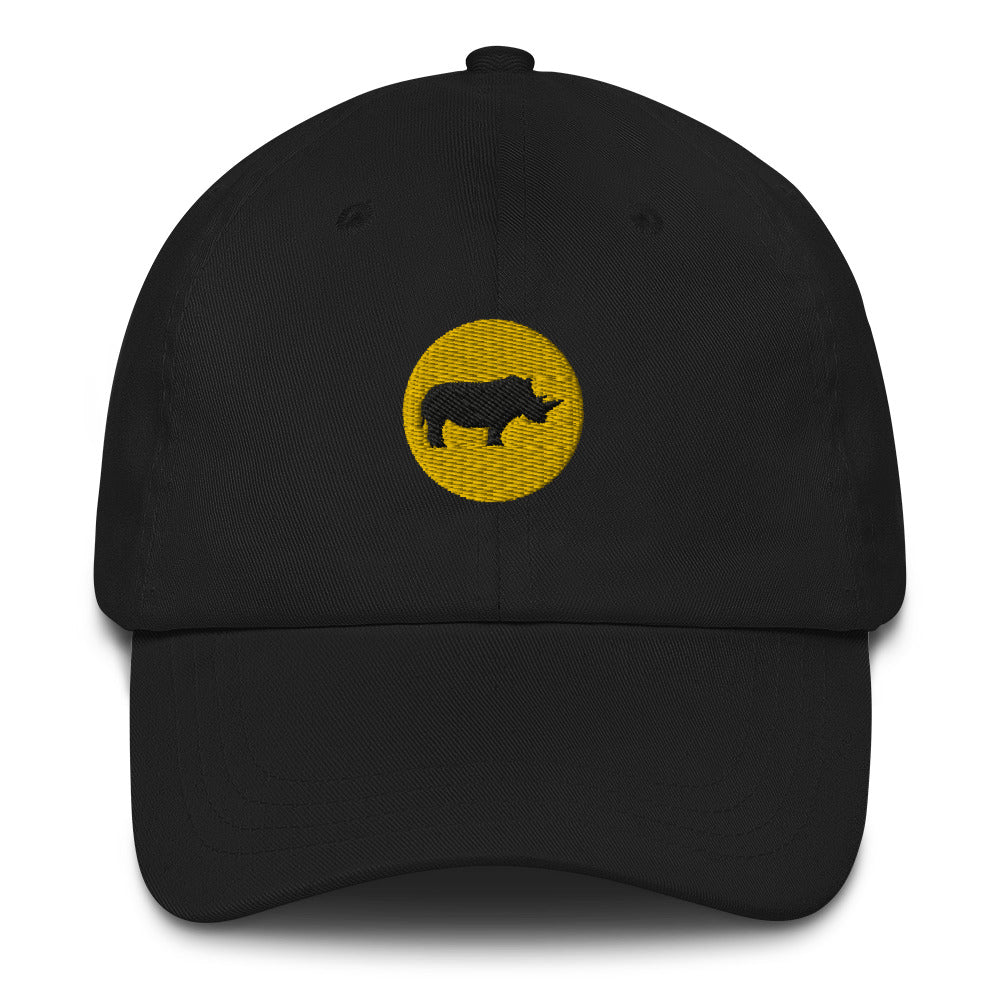 Black dad hat with an embroidered yellow circle and a black rhino in the middle. Close up.